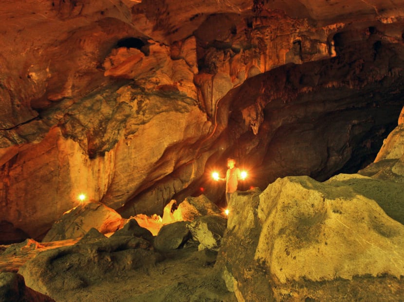 In this Monday, Dec 2, 2013 photo, a guide uses candles to illuminate the interior of a cave which scientists said reveals history of ancient tsunamis in Lhong, Aceh province, Indonesia. Photo: AP
