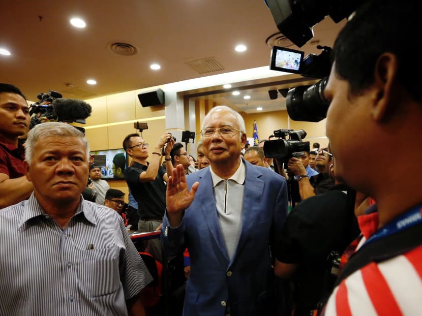 Former Malaysian prime minister Najib Razak leaving a press conference where he announced his resignation from Umno and Barisan Nasional.