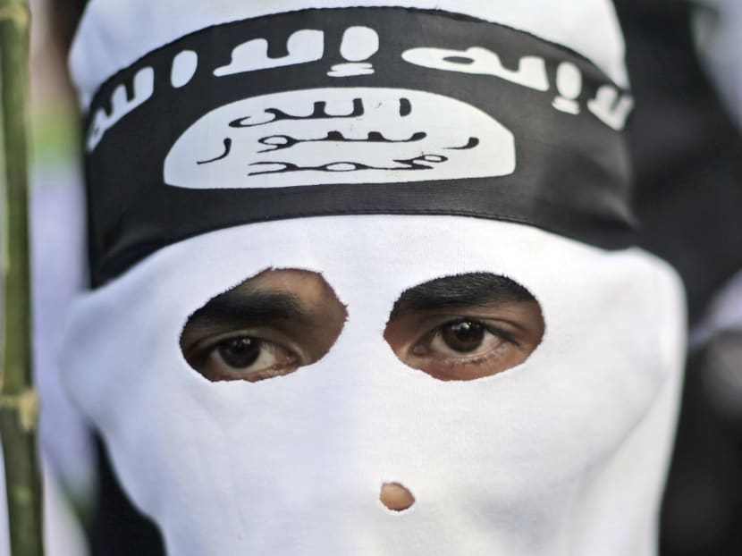 In this June 18, 2014, file photo, a man wears a headband showing the Islamic State group's symbol in Surabaya, Indonesia. Photo: AP