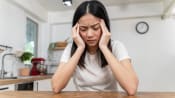 woman headache migrain istock 1351675942