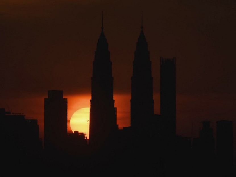 Malaysia's landmark Petronas Twin towers are silhouetted during sunset over the Kuala Lumpur skyline in Ampang, in the suburbs of Kuala Lumpur.