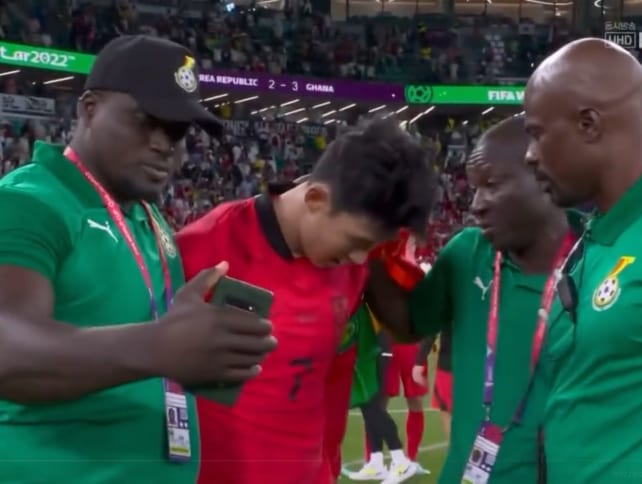 A Ghana team staff member (left) tried to take a selfie with a crying Son Heung-min (second from left), following South Korea's 3-2 loss to Ghana at the Qatar World Cup.