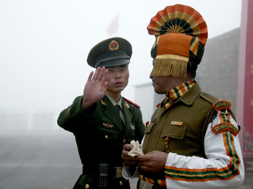 A Chinese soldier with an Indian soldier at the Nathu La border crossing between India and China in Sikkim state. Since mid-June, both countries’ troops have been in a standoff in Doklam, a Himalayan plateau near where Tibet, India and Bhutan meet. Photo: AFP