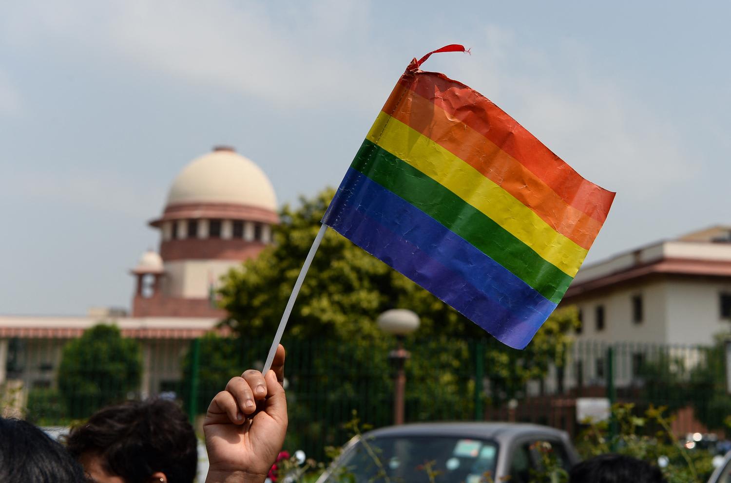 An Indian member of the lesbian, gay, bisexual, transgender (LGBT) community waves a flag outside the Supreme Court building as crowds gathered to celebrate the decision to strike down the colonial-era ban on gay sex in New Delhi on Sept 6, 2018. An Indian member of the lesbian, gay, bisexual, transgender (LGBT) community waves a flag outside the Supreme Court building as crowds gathered to celebrate the decision to strike down the colonial-era ban on gay sex in New Delhi on Sept 6, 2018.