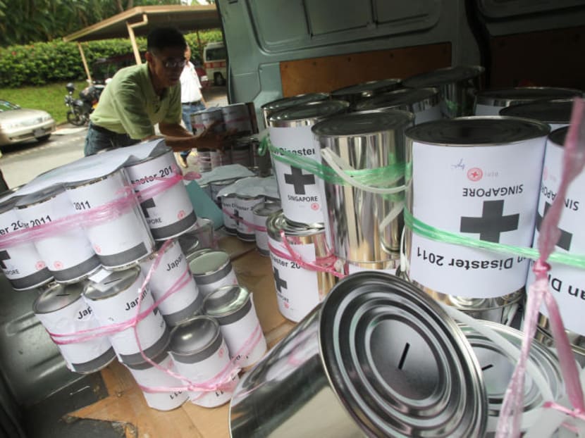 A deliveryman loading donation tins into a van at the Red Cross Singapore headquarters. TODAY file photo
