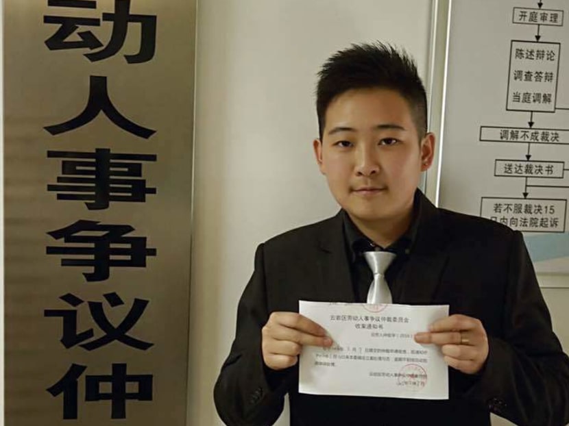 Mr C, a transgender man who has declined to provide his real name, holding a receipt for the complaint he filed with a labour arbitration committee in Guiyang, China. Photo: The New York Times