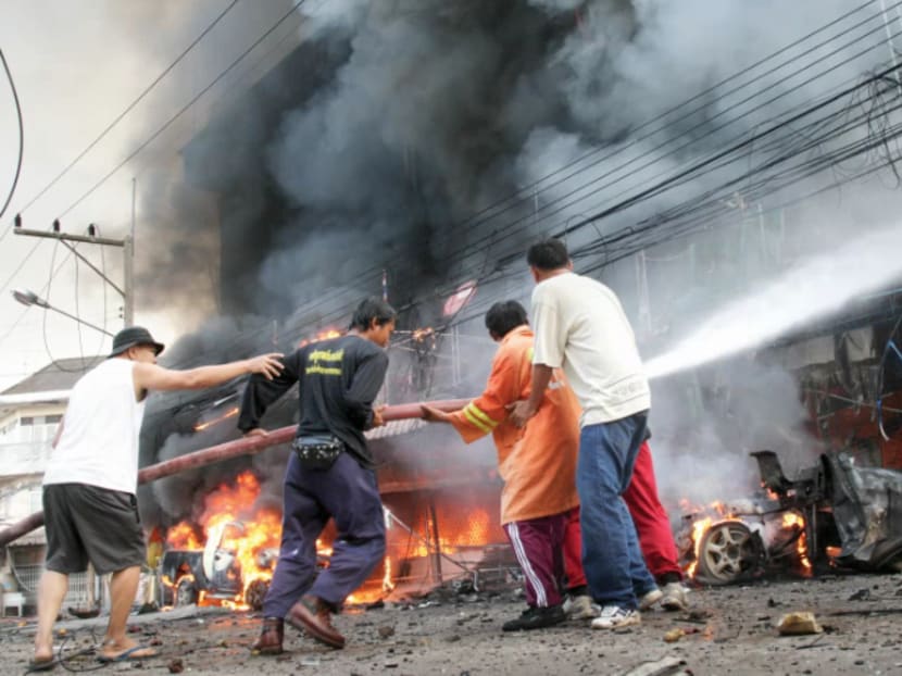 Fire-fighters at the scene of a car-bomb attack outside a four-storey commercial building in southern Thailand's Narathiwat province in 2012. In the last 12 years, more than 6,500 people have been killed as the region fights for local autonomy from Buddhist-dominated Thailand. Photo: REUTERS
