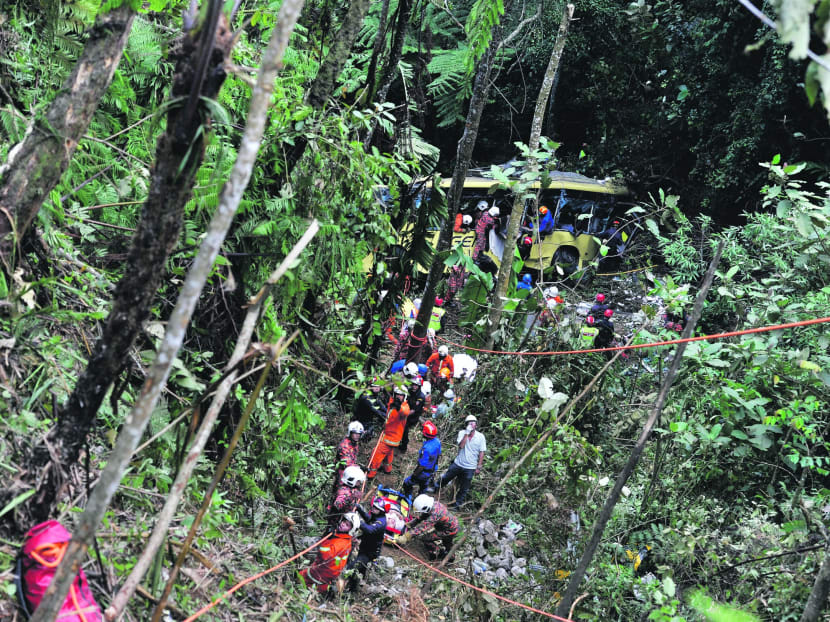 Rescue workers at the scene after a passenger bus plunged into a ravine near Genting Highlands yesterday. Photo: AP