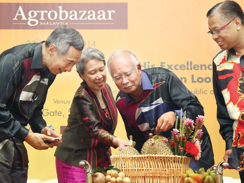 Mr Lee Hsien Loong, his wife Ho Ching and Malaysian Prime Minister Najib Razak at the opening of Agrobazaar yesterday. Photo: Don Wong