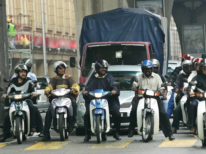 File photo of motorcyclists waiting at a traffic light in Kuala Lumpur, May 25, 2005. Photo: AFP