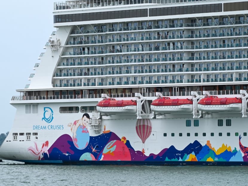 People are seen onboard the Dream Cruises' World Dream cruise ship docked at the Marina Bay Cruise Centre in Singapore on July 14, 2021. 