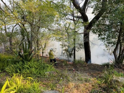 New South Wales Rural Fire Service firefighter Elisabeth Goh monitors a hazard reduction burn in Sydney, Australia, on Sept 10, 2023.