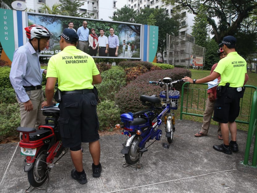 Active mobility enforcement officers checking on a personal mobility device (PMD) in October 2016. Under the new Active Mobility Act, a person is not allowed to ride a bicycle, e-bike or PMD on pedestrian-only paths. TODAY file photo