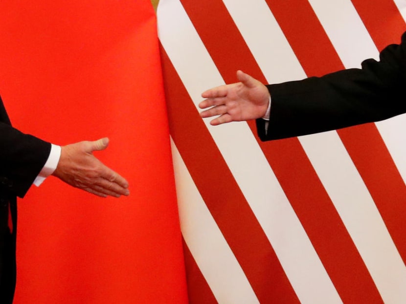 US President Donald Trump and China's President Xi Jinping shake hands in Beijing in Nov 2017. High-level talks between Washington and Beijing have ground to a halt as the Trump administration threatens to escalate a trade war.