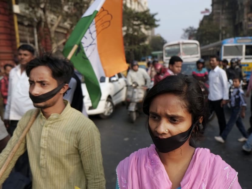 Activists of Indian National Congress with black bands around their mouth block traffic during a protest against a gang-rape and murder of a 16-year-old girl. Photo: AP