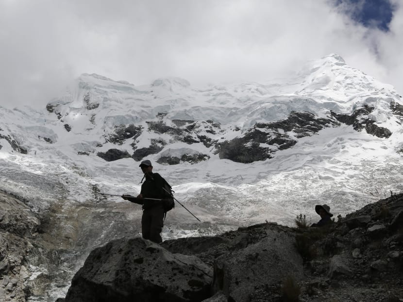 People walk near the Hualcan glacier in the Huascaran natural reserve in Ancash on Nov 29, 2014. Peru is home to 71 per cent of the worlds tropical glaciers, which are a source of fresh water for millions, but 22 per cent of the surface area of Peruvian glaciers has disappeared in the past 30 years alone, according to The World Bank. Photo: Reuters