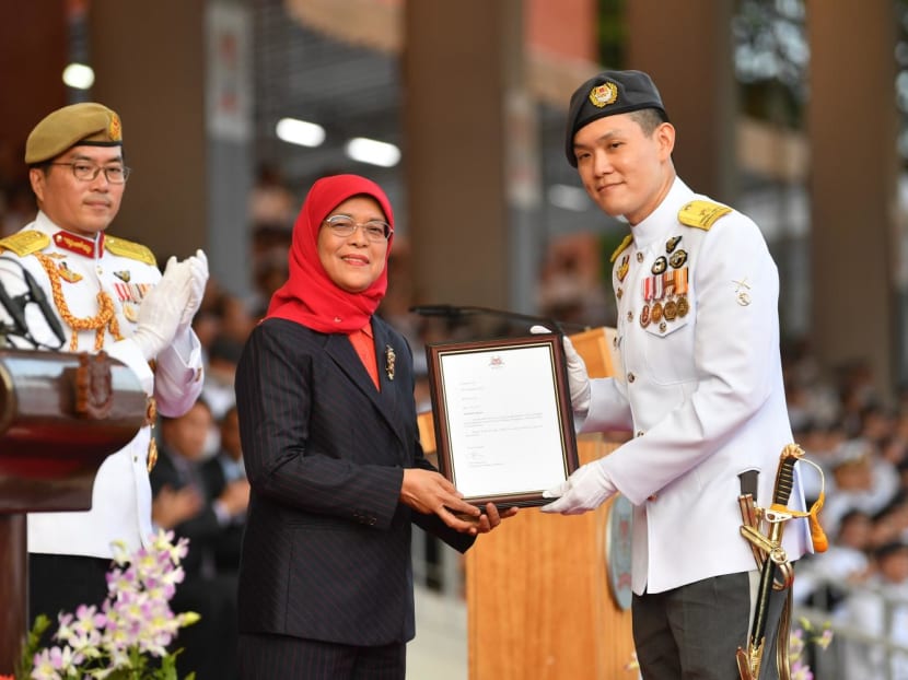 Brigadier-General Lee Yi-Jin (right) being presented the letter of appointment as the Chief of the Digital and Intelligence Service by President Halimah Yacob (centre). 