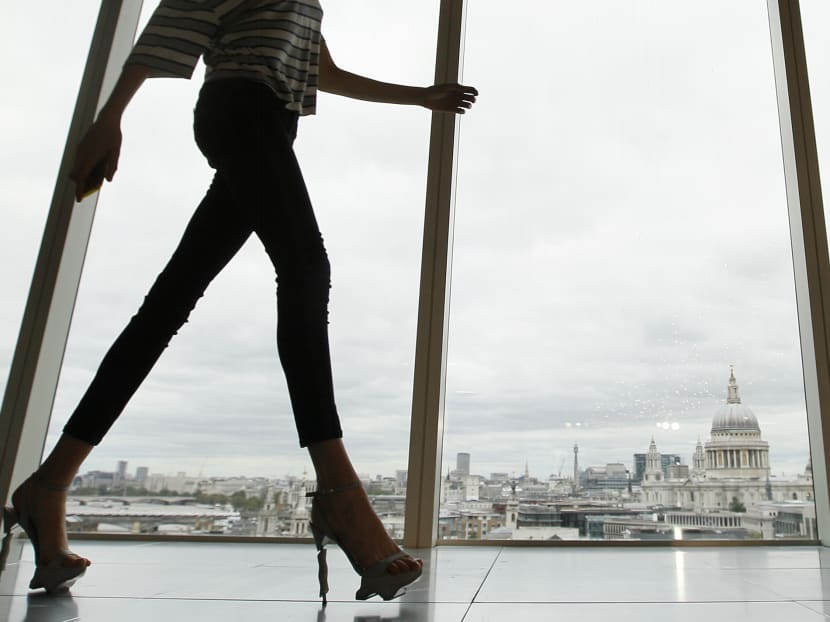 A model walks past a window with a view of St Paul's Cathedral during the presentation of the Matthew Williamson Spring/Summer 2013 collection at London Fashion Week on September 16, 2012. Photo: AP