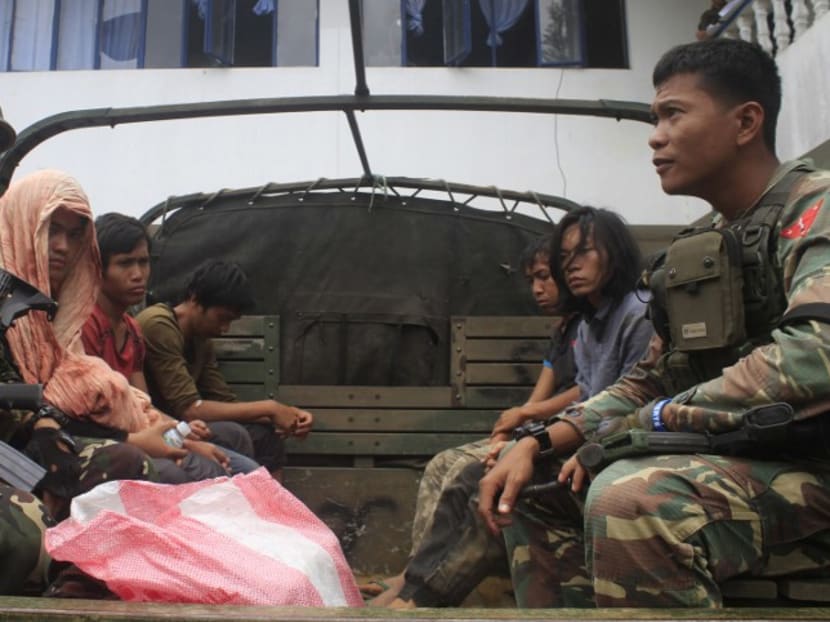 This photo taken on August 23, 2016 shows Philippine soldiers guarding members of the Maute extremist group in Marawi City in the southern island of Mindanao. Photo: AFP