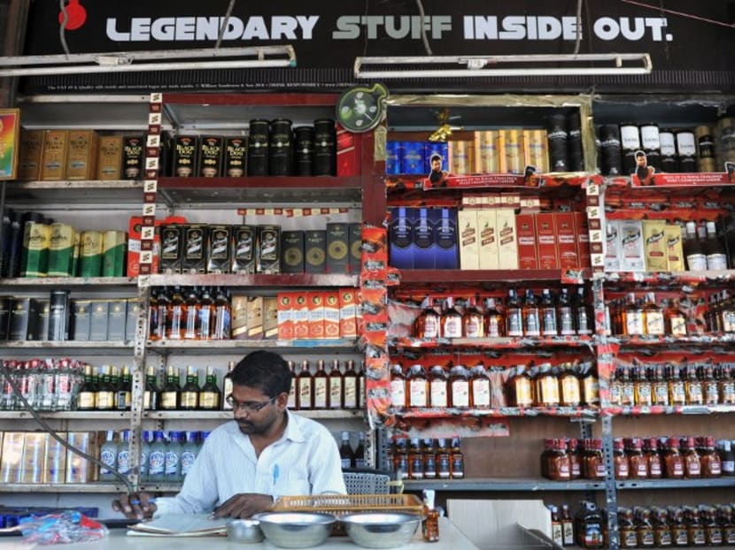 An Indian employee at an alcohol store in Hyderabad in 2013. Photo: AFP