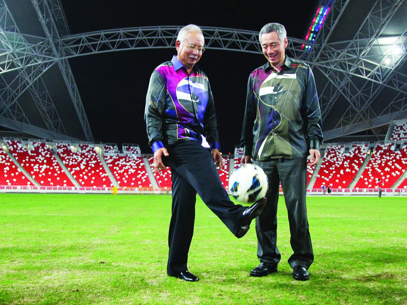 Malaysia's PM Najib Razak juggles a football during his visit to the National Stadium with PM Lee Hsien Loong. TODAY file photo