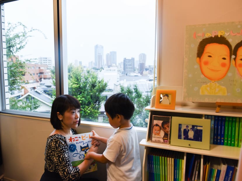 Ms Yukie Watabe with her five-year-old son at home, which she also uses as her office. Though thousands of day care slots have been added in Japan, they've filled up quickly, and long waiting lists remain, keeping women at home even if they want to go back to work.
