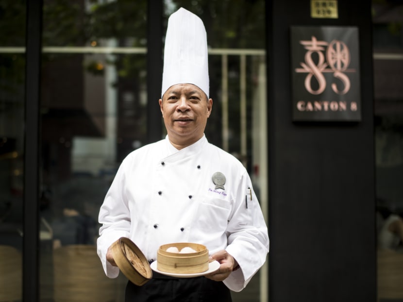 Master chef of Canton 8 restaurant, Jie Ming Jian poses with his cheapest dish of 'prawn dumplings' in front of the restaurant, which was awarded two Michelin stars on Sept 21, 2016. Photo: AFP