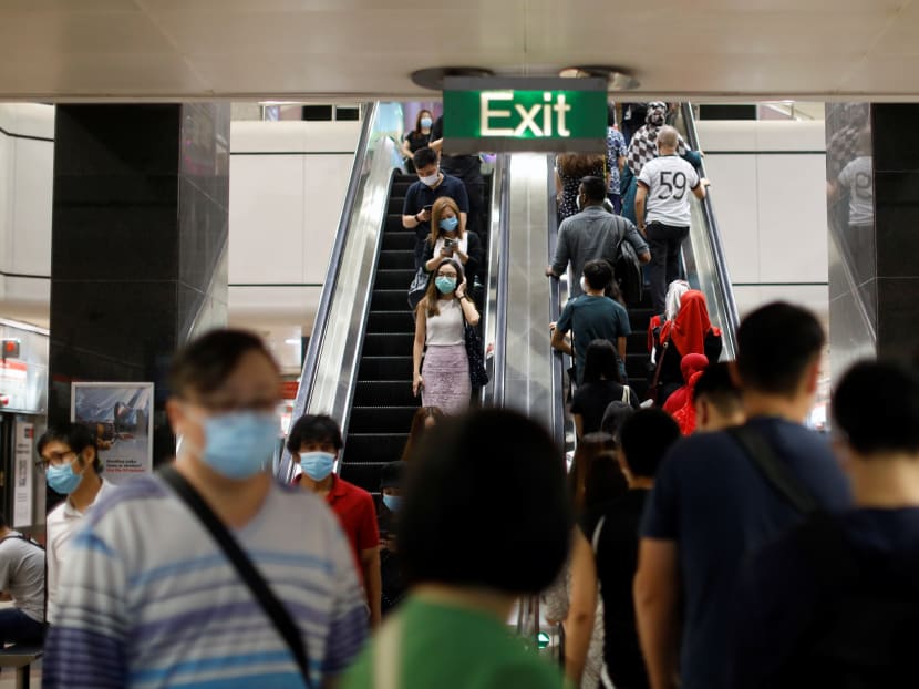 Commuters wearing protective face masks leave a train station during the Covid-19 outbreak in Singapore on Aug 17, 2020. Commuters wearing protective face masks leave a train station during the Covid-19 outbreak in Singapore on Aug 17, 2020.