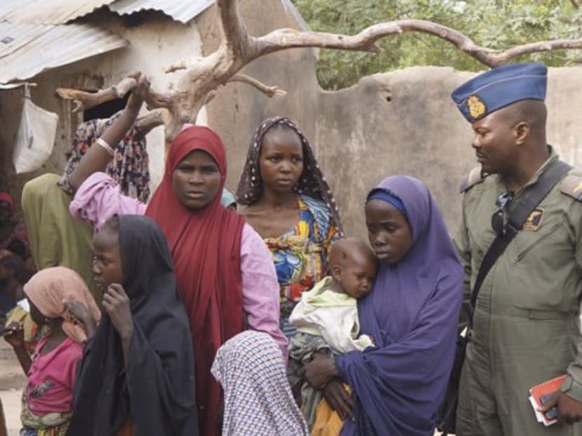 A soldier from the Nigerian Army talks with hostage women and children who were freed from Boko Haram, in Yola, in this April 29, 2015 handout. Photo: Reuters