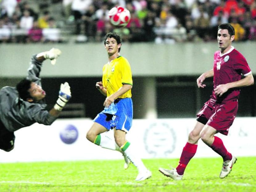 Alexandre Pato (centre) in action for Brazil against a Singapore Selection side at the National Stadium in 2008. In this photo, his shot is saved by Singapore keeper Hassan Sunny (left) as Singapore defender Daniel Bennett looks on. TODAY FILE PHOTO