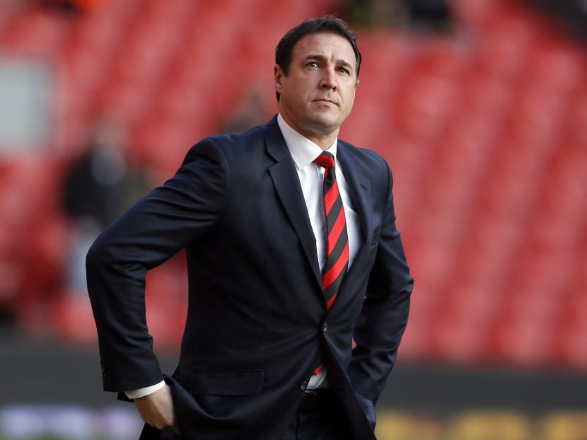 File photograph shows Cardiff City's manager Malky Mackay walking onto the pitch before their English Premier League soccer match against Liverpool at Anfield in Liverpool, northern England, Dec 21, 2013. Photo: Reuters