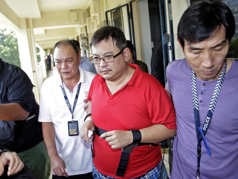 Teo Ghim Heng (second from right), who killed his wife and daughter, being escorted back to the crime scene on Feb 10, 2017. Teo Ghim Heng (second from right), who killed his wife and daughter, being escorted back to the crime scene on Feb 10, 2017.