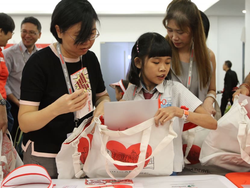 A student packs a funpack. This year, the funpack will showcase 18 artworks by special needs students.