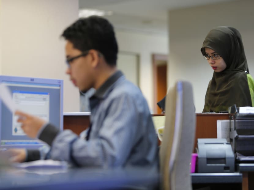 Malaysian government employees work inside the Land Puclic Transport Commission (SPAD) office in Putrajaya. Mr Najib said non-Muslim staff would be allowed to take seven days of unrecorded leave for religious events yearly while there would be a special haj quota for retired Muslim staff. Malaysian government employees work inside the Land Puclic Transport Commission (SPAD) office in Putrajaya. Mr Najib said non-Muslim staff would be allowed to take seven days of unrecorded leave for religious events yearly while there would be a special haj quota for retired Muslim staff.