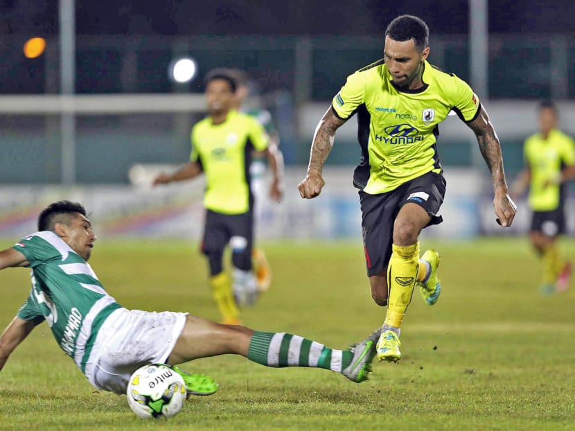 Tampines Rovers player Jermaine Pennant (yellow) in full flight against Geylang International. The two clubs sent fans’ hearts racing with a 3-3 draw in the opening week. Photo: Wee Teck Hian