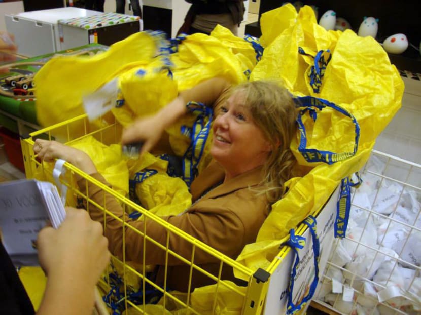 A woman takes part in a game of hide-and-seek at an IKEA store in Wilrijk, Belgium. Photo: Bloomberg