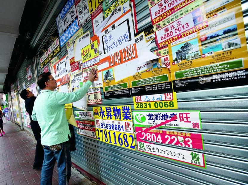 Real-estate advertisements in Hong Kong. Home buying curbs may affect 10,000 agents. Photo: Bloomberg