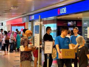 The queue for banking services outside a DBS and UOB branch at Toa Payoh Hub on Jan 11, 2023.