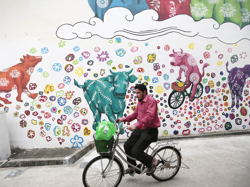 A mural titled Cattleland 2, by Eunice Lim, part of the third edition of ARTWALK Little India, a public art festival, featuring over 18 outdoor art installations, live music and dance acts. ARTWALK Little India will be open to public from Jan 12-17, 2017 and is self-guided. Photo: Jason Quah/TODAY