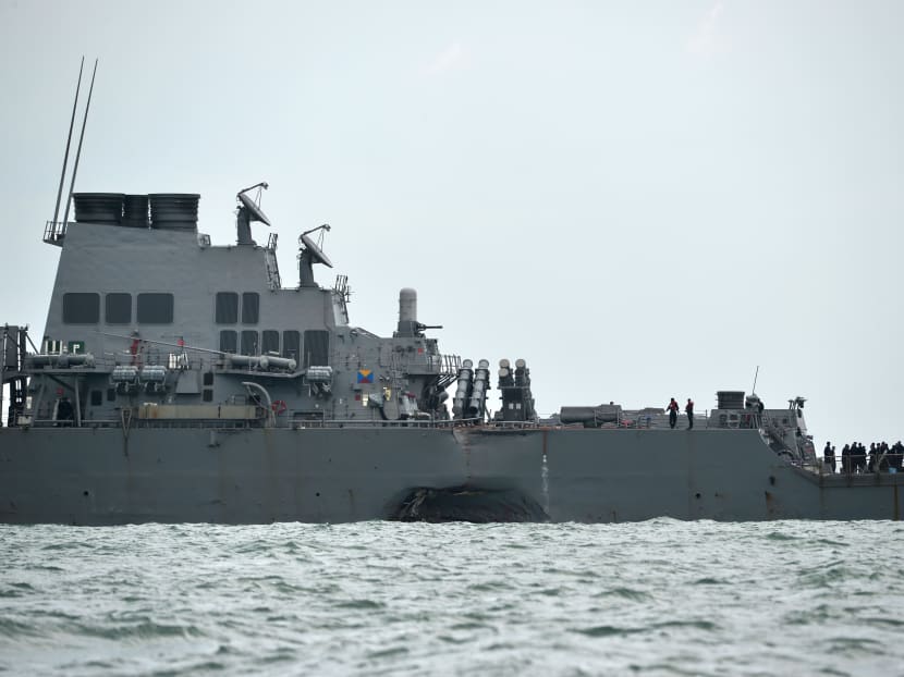 The  USS John S McCain with a hole on its left portside after a collision with oil tanker, outside Changi naval base in Singapore on Aug 21, 2017. The collision followed another one in June between destroyer USS Fitzgerald and a freighter off Japan, killing seven US sailors.  Photo: AFP