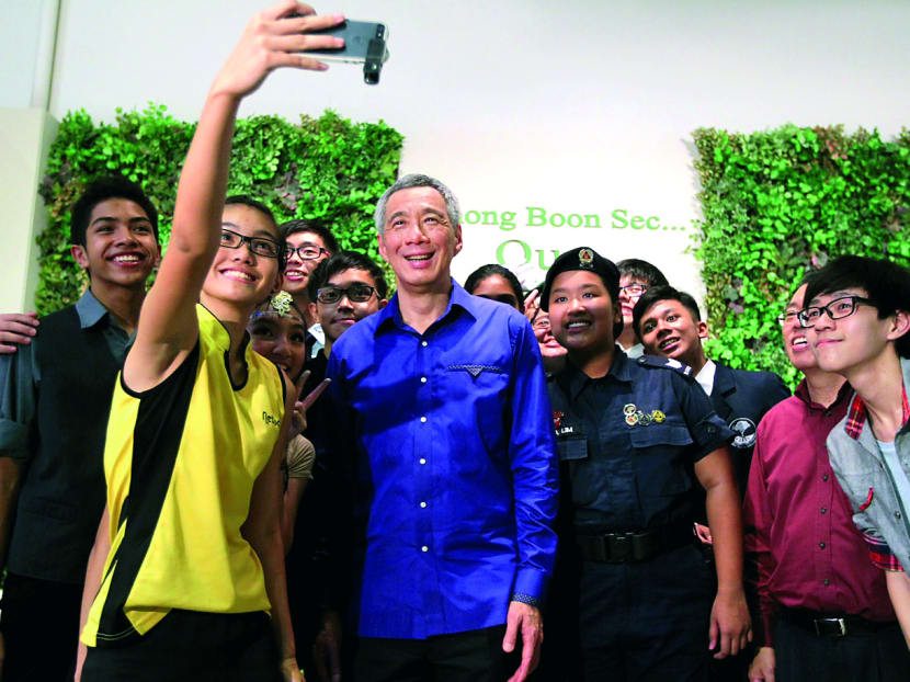 PM Lee Hsien Loong with a student from Chong Boon Secondary School during the school’s 20th anniversary celebrations yesterday. Photo: Don Wong