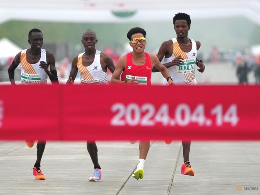 Chinese runner He Jie, Ethiopian Dejene Hailu Bikila and Kenyans Robert Keter and Willy Mnangat take part in a half-marathon in Beijing, China April 14, 2024.