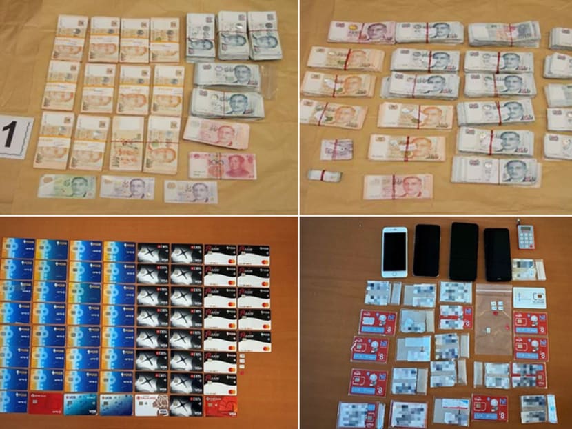 Cash, bank cards, phones and other items seized by the police in Singapore as part of a joint operation with Hong Kong police.