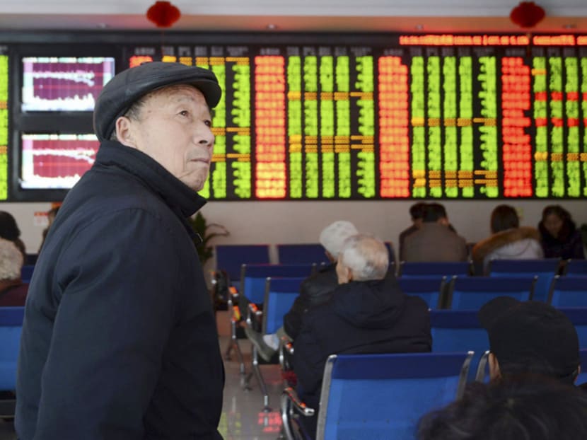 An investor looks on as the SCI falls sharply. The plunge comes ahead of a decision by the IMF next Monday on whether to include the yuan in its global reserve basket. Photo: REUTERS