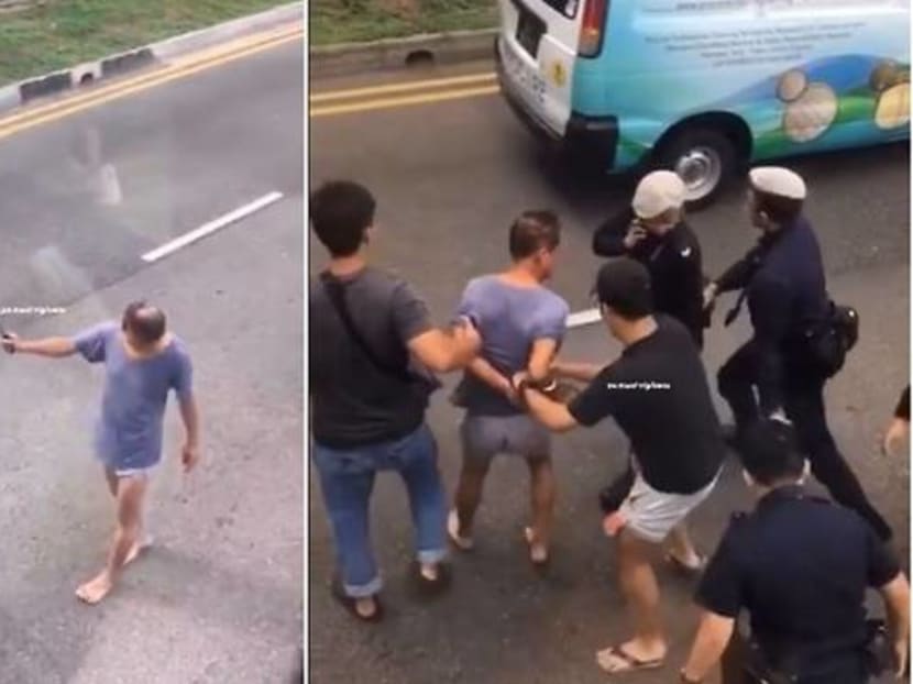 Screengrabs of a video posted on social media showing a man wielding a hammer along Bedok North Road on Nov 27, 2019.