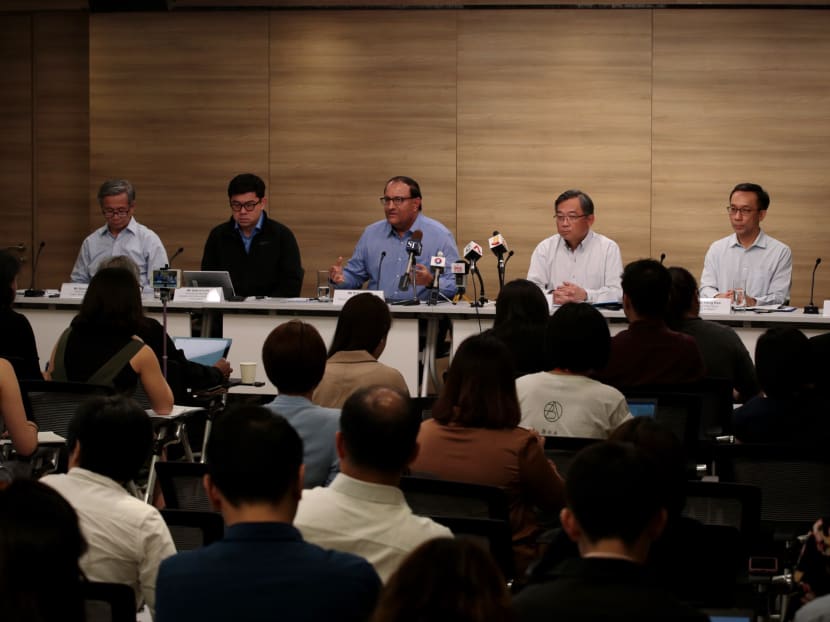 Minister for Communications and Information S Iswaran (C) speaks alongside Minister for Health Gan Kim Yong (3rd R) during a press briefing on a 'major cyber attack' on SingHealth, July 20, 2018.