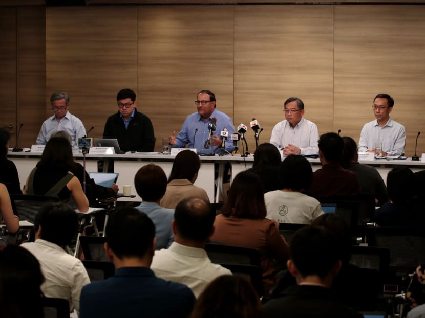 Minister for Communications and Information S Iswaran (C) speaks alongside Minister for Health Gan Kim Yong (3rd R) during a press briefing on a 'major cyber attack' on SingHealth, July 20, 2018. Minister for Communications and Information S Iswaran (C) speaks alongside Minister for Health Gan Kim Yong (3rd R) during a press briefing on a 'major cyber attack' on SingHealth, July 20, 2018.