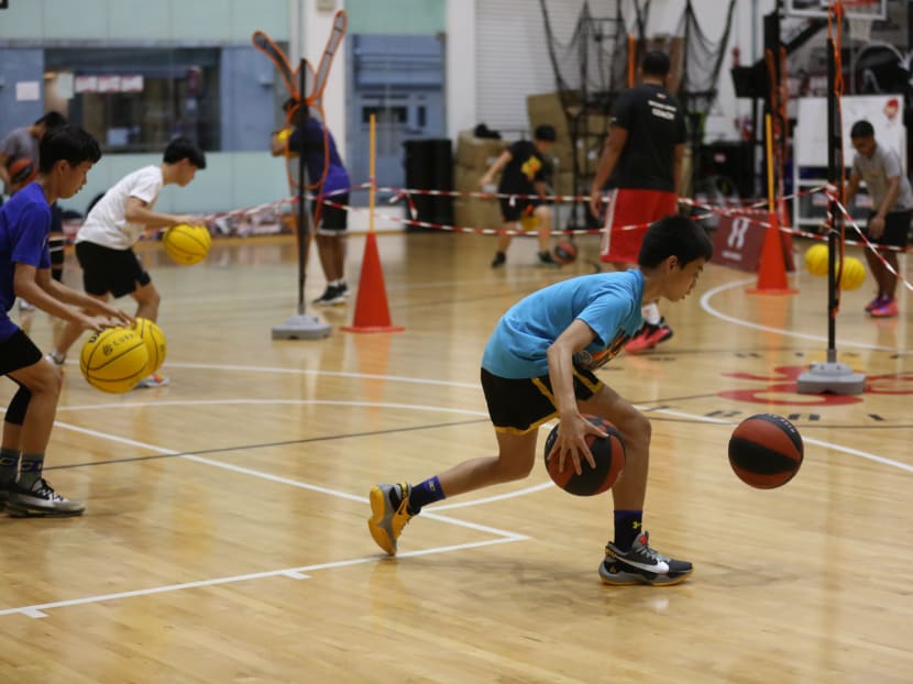Youths are seen training at an indoor basketball court on Feb 6, 2022.