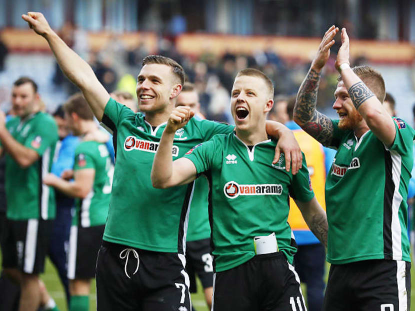 Lincoln’s Alan Power, Terry Hawkridge and Jonathan Jack Muldoon celebrating their win over Premier League side Burnley, which made them the first non-league side in 103 years to reach the last eight. Photo: Reuters