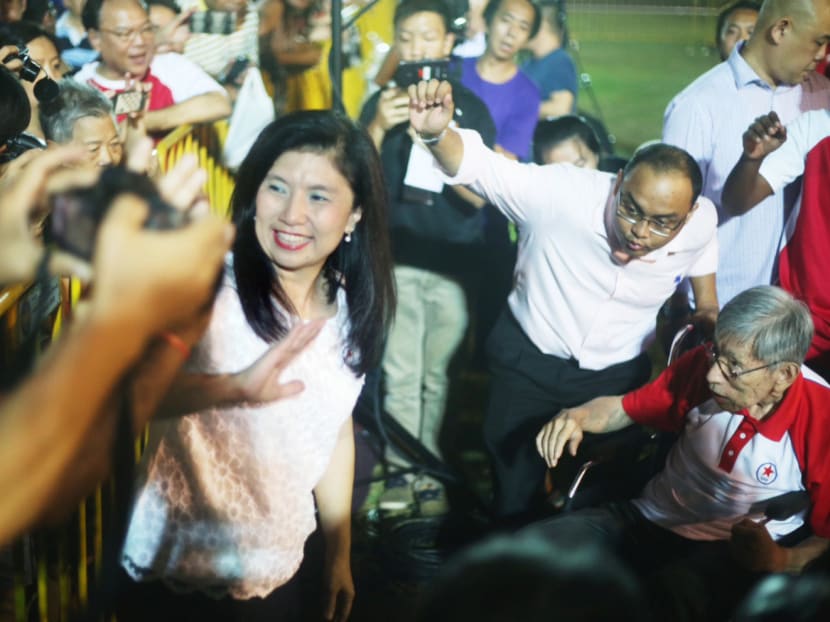 Mrs Jeannette Chong-Aruldoss and veteran opposition politician Chiam See Tong meeting supporters after the SPP rally last night. The SPP candidate said not enough is being done to arrest income inequality. Photo: Don Wong